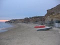 Beach with some boats on the sand on sunset to Anzio in Italy.