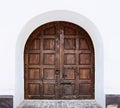 Ancient beautiful gate door. White wall. Royalty Free Stock Photo