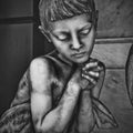 Little sad kid praying with the eyes closed Royalty Free Stock Photo