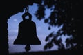 Ancient bell silhouette in church, place of relaxation and worship, religion concept at sunset