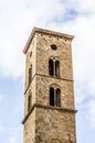 Ancient bell tower with bells and flag of the historic city Royalty Free Stock Photo