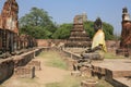 Ancient big buddha statue against ruined statues