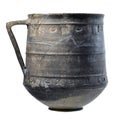 An ancient black clay jug from Roman times with ornamentation on a white background