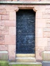 An ancient black studded door
