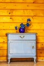 Ancient blue drawers placed in front of wooden wall