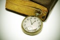 Ancient book and pocket watch Royalty Free Stock Photo