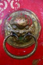 Ancient lion head door knocker on a red door in Tovkhon Monastery, Ovorkhangai Province, Mongolia. UNESCO World Heritage Site. Royalty Free Stock Photo
