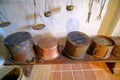 Ancient brass pots. Medieval kitchen metal cooking utensils. Interior of the kitchen of an old castle. Latvia Bauska