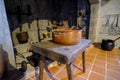 Ancient brass pots. Medieval kitchen metal cooking utensils. Interior of the kitchen of an old castle. A pot is placed