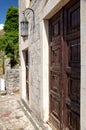 Ancient brick building in the fortress old bar, Montenegro. Antique wooden door and old lantern.