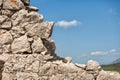 Ancient brick old stones wall with the blue sky as the background Royalty Free Stock Photo