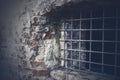 Ancient brick wall and window locked with metal bars Royalty Free Stock Photo