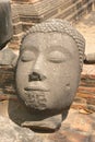 Ancient broken Buddha head with serene expresssion
