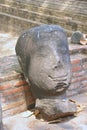 Ancient broken Buddha head with serene expression