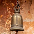Ancient Bronze Bell Hanging on Weathered Wall Royalty Free Stock Photo