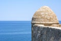 Ancient brown stone wall near the blue sea and blue sky