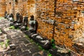 Ancient Buddha statue articulate are red brick wall