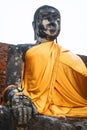 Ancient Buddha statue with shiny yellow robe, in Ayutthaya, Thai