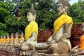 Ancient statues of meditating buddha sitting, at Wat Yai Chaimongkol old temple in Ayutthaya, Thailand Royalty Free Stock Photo