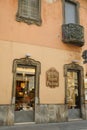 Ancient building with shops in the historic center of Busto Arsizio. Palace and sign in neo-Baroque style