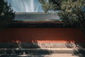 The ancient buildings with red wall, gray tile roof, and tree shadows in the Forbidden City, Beijing, China Royalty Free Stock Photo