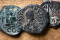 Ancient Byzantine follis coins on vintage background, top view, old worn bronze Roman Greek money close-up. Concept of Rome,