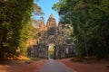 Ancient Cambodian face tower over the northern entrance gate of Angkor Thom city, surrounding Angkor Wat temple complex, in Siem R