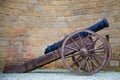 The ancient cannon close-up against the backdrop of the fortress wall of the Old City. Baku, Azerbaijan Royalty Free Stock Photo