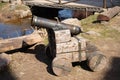 ancient cannon on wooden wheels stands near the pond