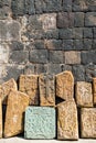 Ancient carved stone slabs with intricate patterns against a rugged wall