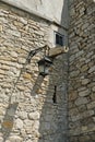 Ancient castle with street lamp, window and water pipe for the Royalty Free Stock Photo