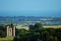 Ancient castle watchtower on green meadows seen from above Royalty Free Stock Photo