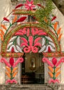 Ancient catholic church entry door mexico flower decoration green old tree blue sky