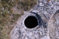 The ancient cave city of Bakla, outside view. Round grain pits for grain storage