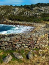 Ancient celtic wall close to the sea and vegetation Royalty Free Stock Photo