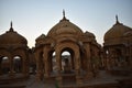 Ancient cenotaph with modern windmills in bada baag Jaisalmer Rajasthan India Royalty Free Stock Photo