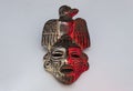 An ancient ceramic pre columbus mask based in American indigenous tribes art iluminated by red and white lights