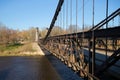 Ancient chain suspension bridge 1853 in the sunny afternoon. City Ostrov, Russia