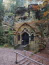 Ancient chapel carved in sandstone rock Modlivy Dul dedicated to the Virgin Mary of Lourdes in beautiful autumn forest near Royalty Free Stock Photo