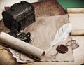 Ancient chest with paper, feather and compass