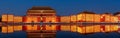 Ancient chinese architecture at night with illuminated lanterns and reflective water surface Royalty Free Stock Photo