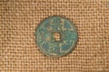 Ancient Chinese bronze coin on old cloth Royalty Free Stock Photo