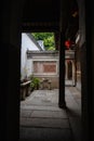 Ancient Chinese entranceway and courtyard with green vegetation