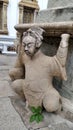 Ancient Chinese soldier stone sculpture carry the pagoda at Wat Po