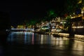 An ancient Chinese street along the river with lights