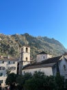 Ancient church of St. Mary with a bell tower at the foot of the mountains. Kotor, Montenegro Royalty Free Stock Photo