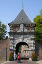 Ancient city gate Veerpoort and walking family