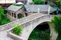 The ancient city of Mostar, Bosnia and Herzegovina. View of an alley with a river and a bridge in a small old town Royalty Free Stock Photo