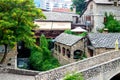 The ancient city of Mostar, Bosnia and Herzegovina. View of an alley with a river and a bridge in a small old town Royalty Free Stock Photo