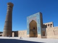 Ancient city under blue sky: square with minaret tower and mosque entrance Royalty Free Stock Photo